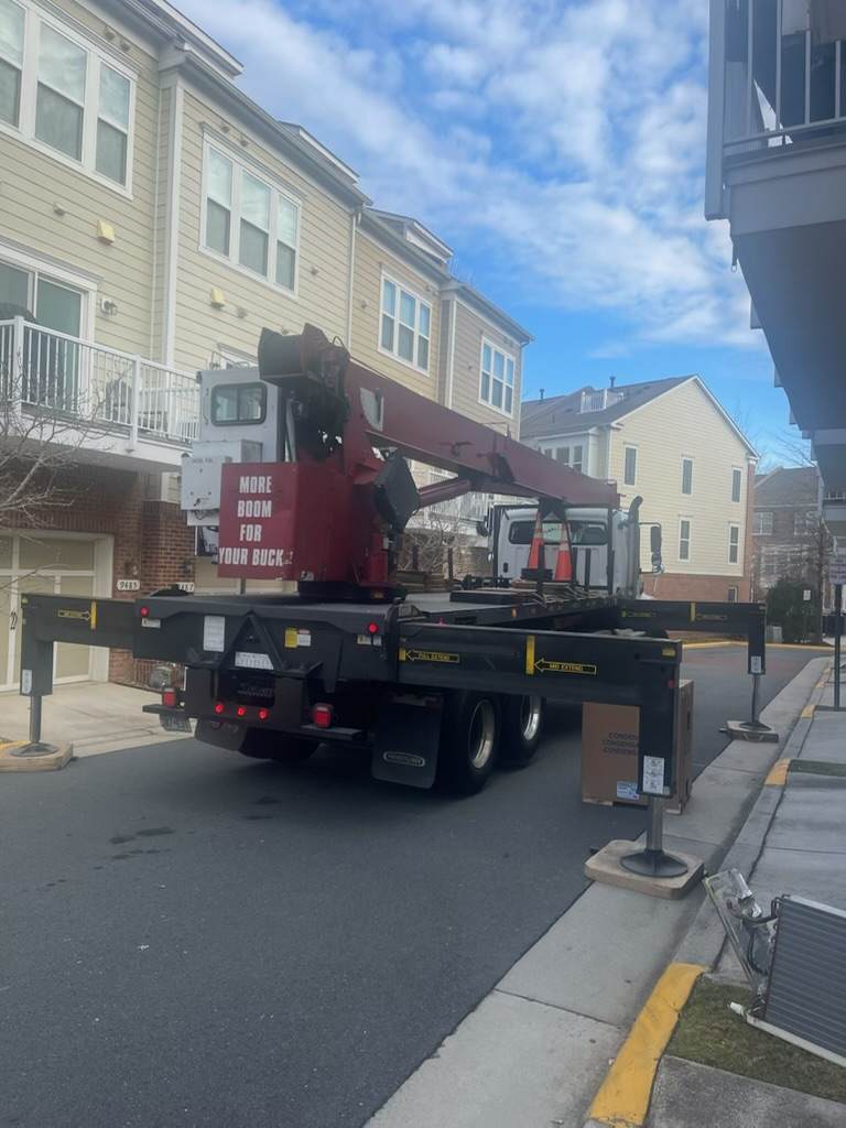 Boom truck deployed in laurel maryland in narrow townhome neighborhood for AC condensor