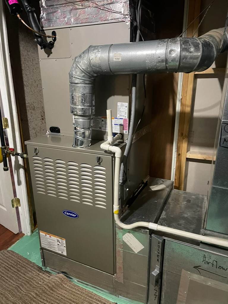 High-efficiency furnace installed in a residential utility area.