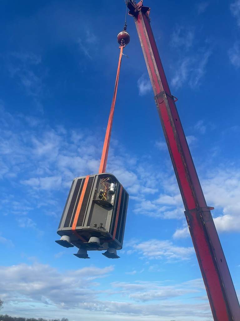 Condensor lifted with a crane to the rooftop of a school in hanover maryland