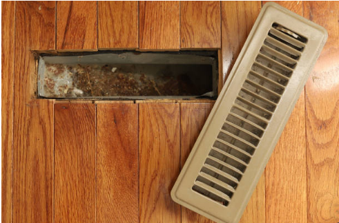 Dust-loaded HVAC vent showing buildup that affects airflow and winter air quality.